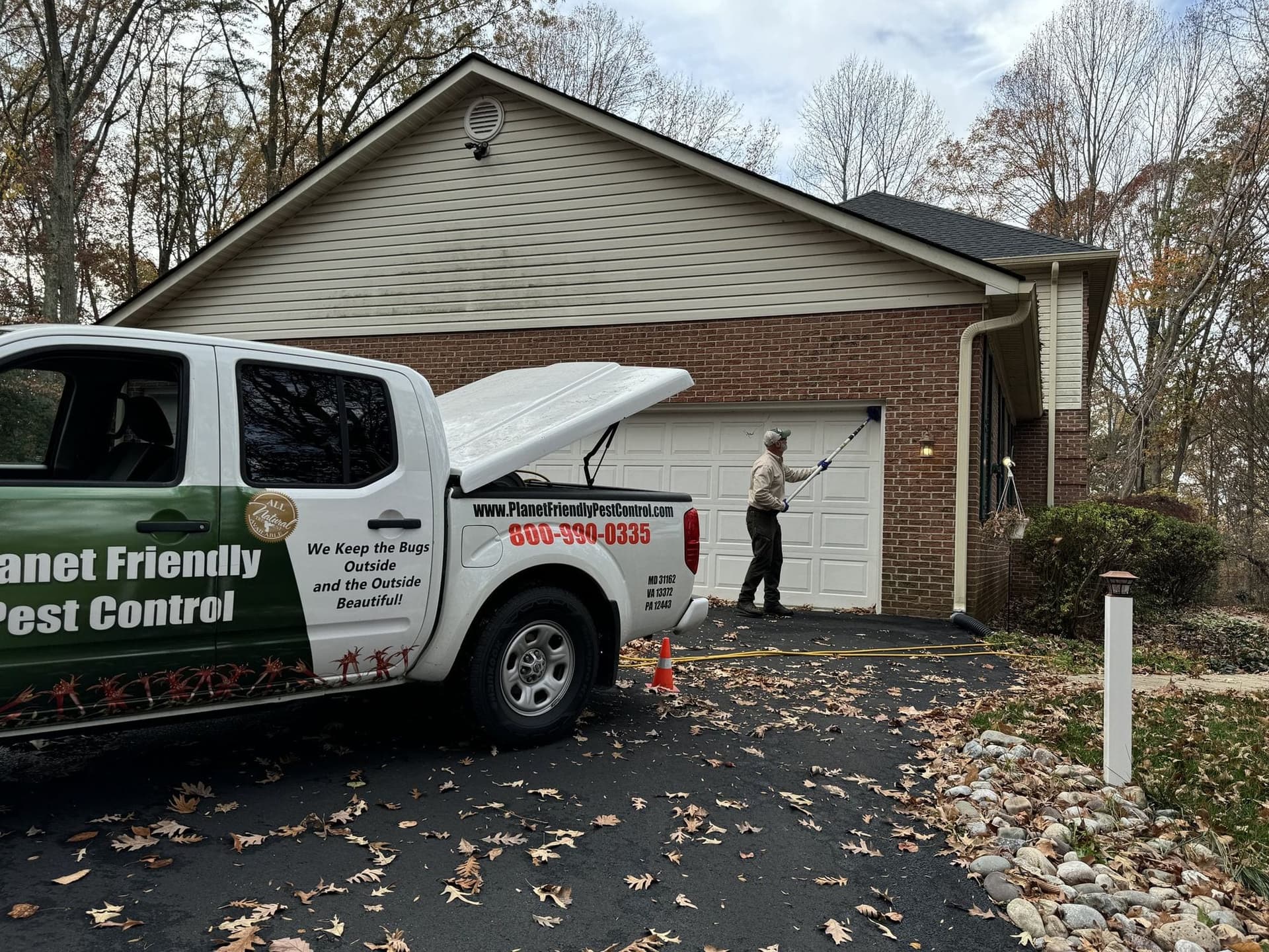 A Planet Friendly Pest Control truck and technician at a home in Southern Maryland