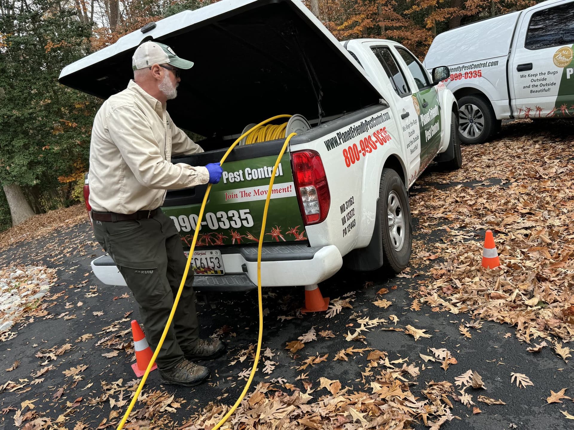 A Planet Friendly Pest Control technician preparing equipment at the truck