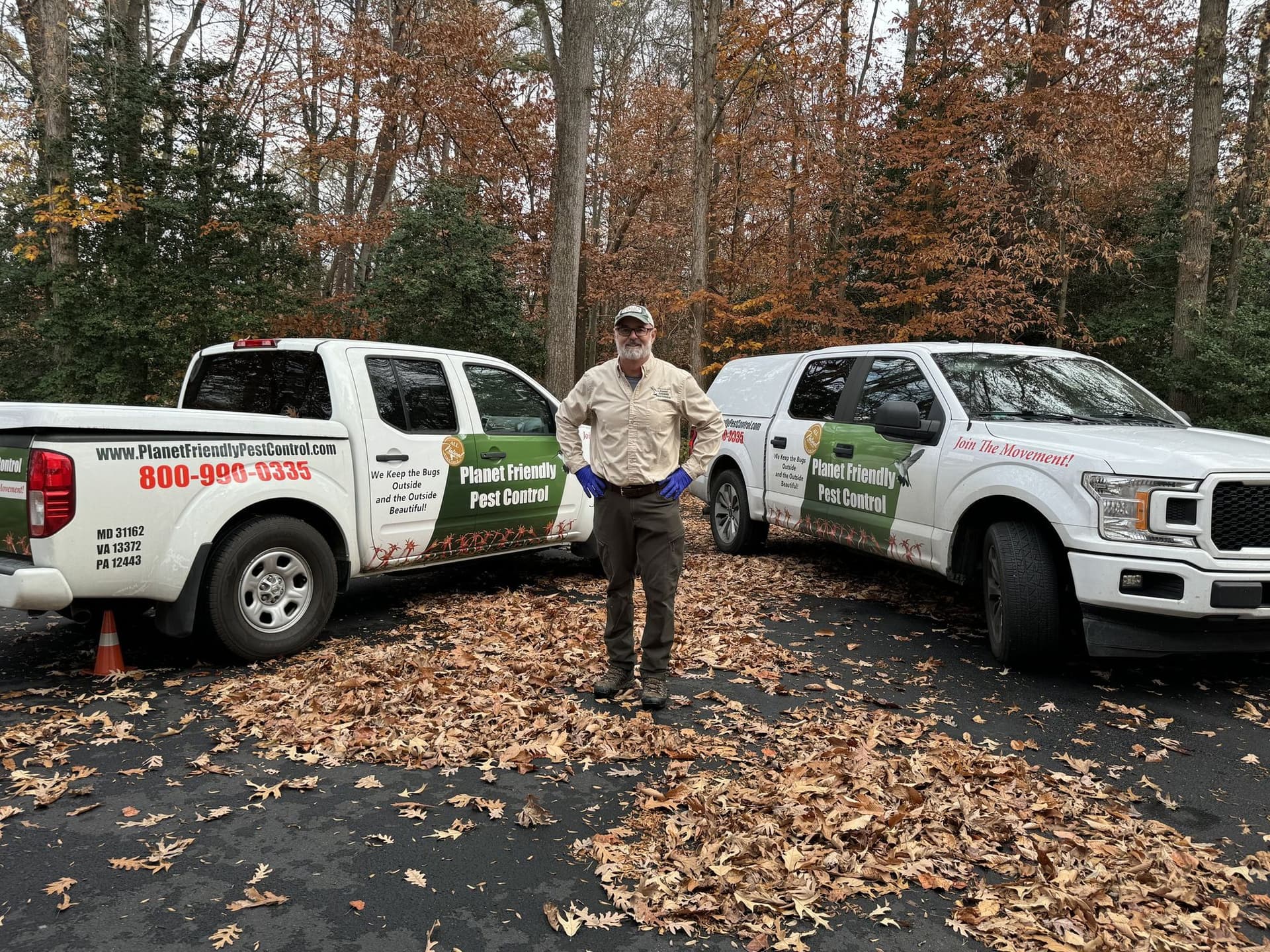 Planet Friendly Pest Control trucks and technicians at a home