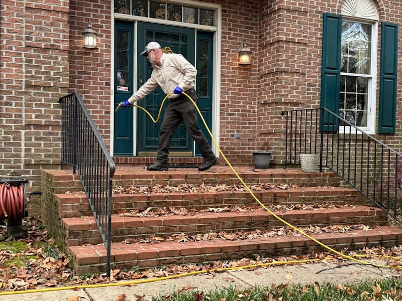 A Planet Friendly Pest Control technician performing an exterior treatment near Clements MD