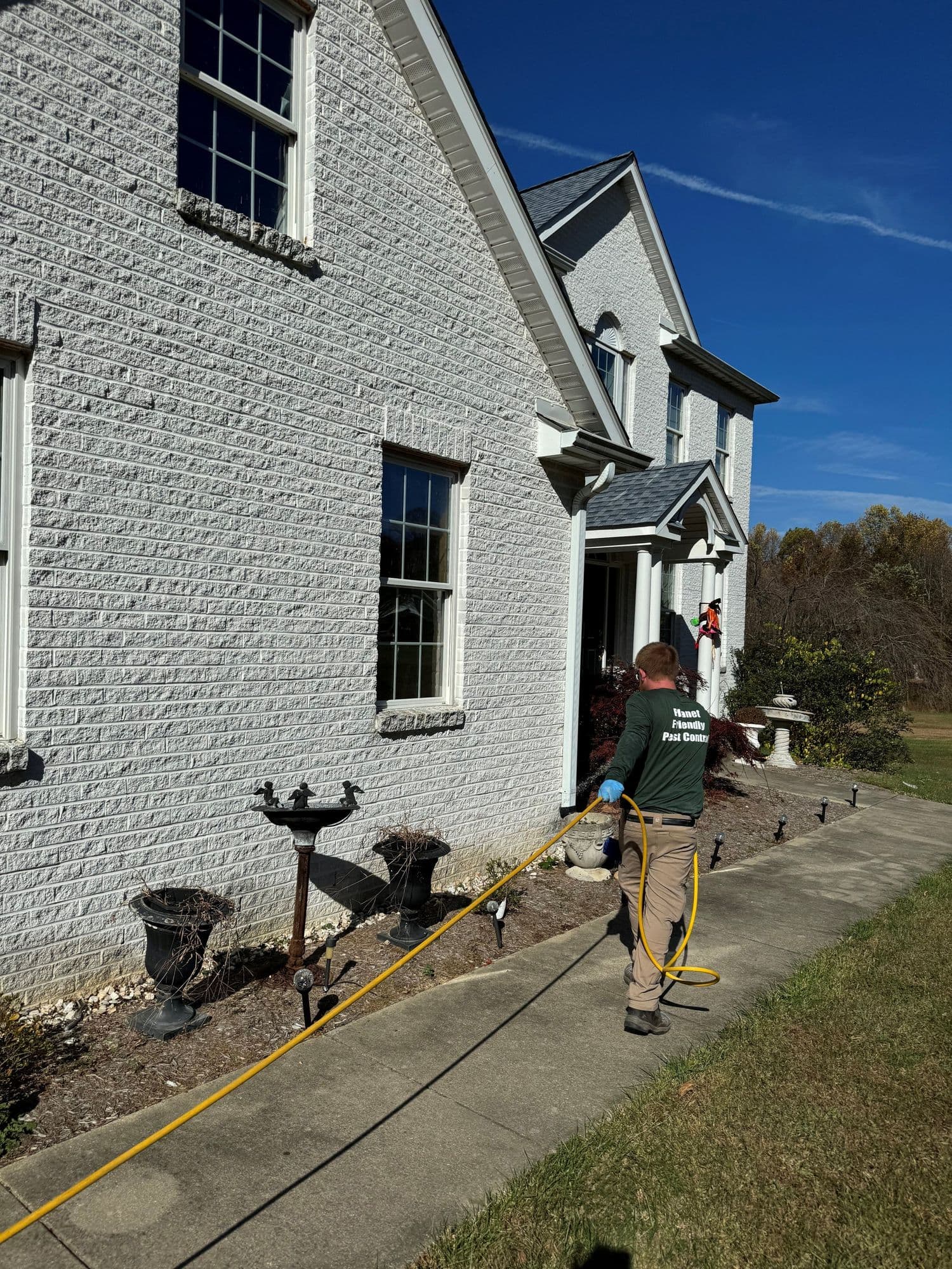 A Planet Friendly Pest Control technician performing an exterior treatment near St Marys County MD