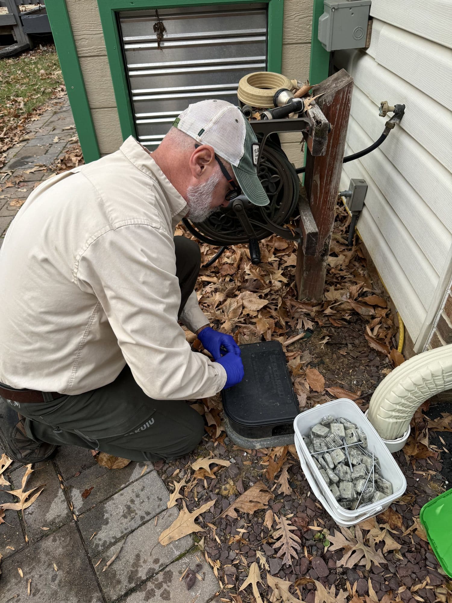 A Planet Friendly Pest Control technician performing an exterior treatment near Herndon VA