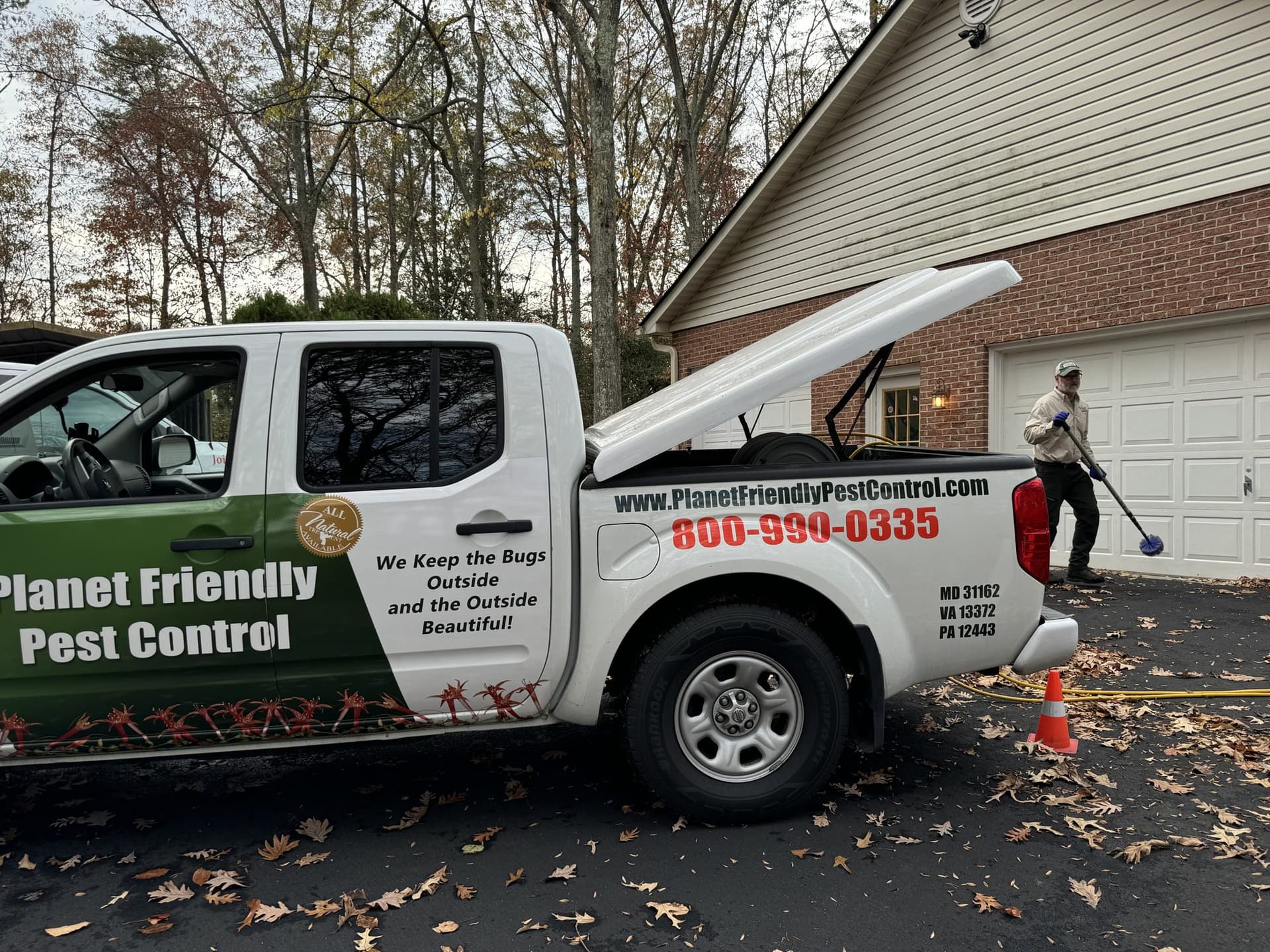 A Planet Friendly Pest Control service truck at a home