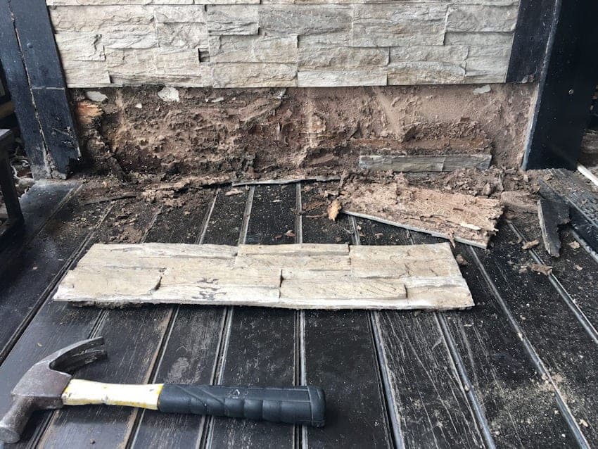 Close-up of termite activity near a home's foundation