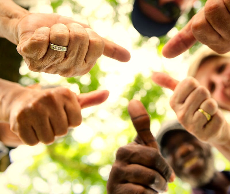 Group of senior friends outdoors thumbs up for community Lyme Disease Prevention