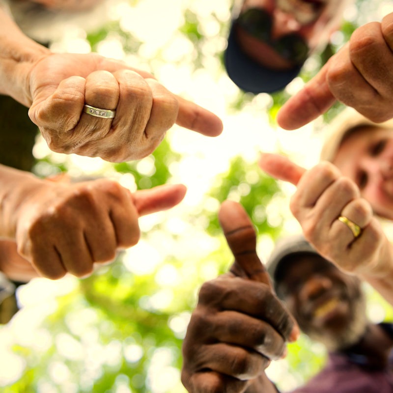 Group of senior friends outdoors thumbs up for community Lyme Disease Prevention